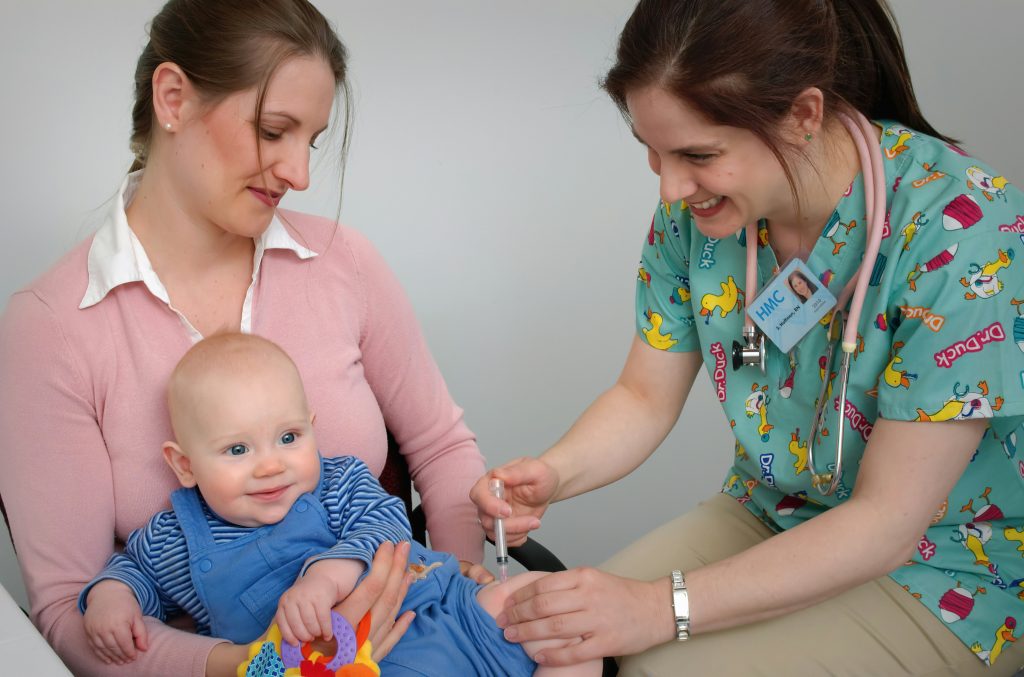 A paediatrician giving a baby a vaccine injection
